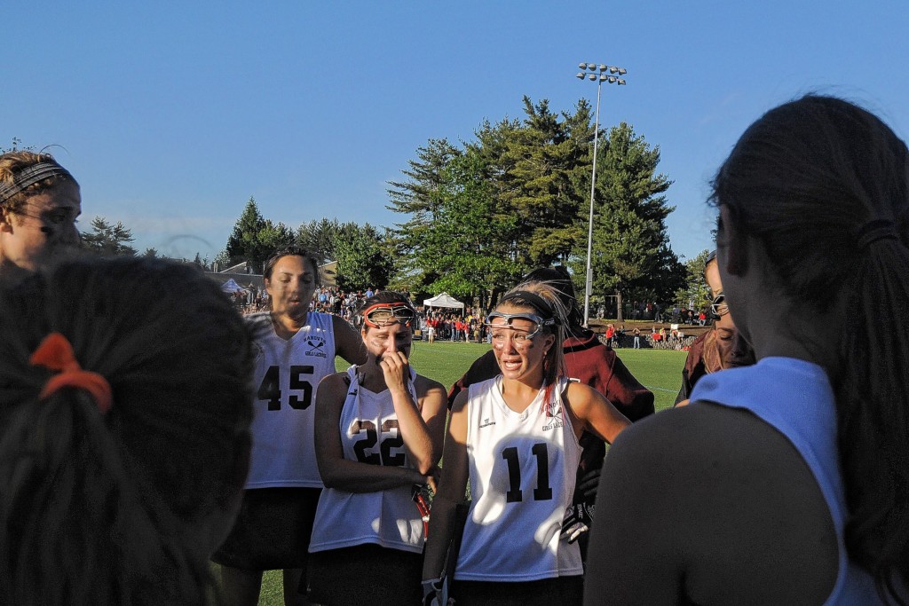 Suriya Lacy, Sarah Gallimore and Claudia have an after-game huddle after their loss to Portsmouth in the Div II Girls Lacrosse Championships. Photo by Sarah Priestap, courtesy of Valley News.