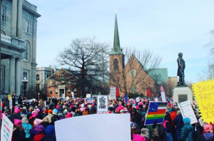 Protesters march in front of New Hampshire's state house in Concord on January 20th in one of many Women's Marches going on across the United States that weekend in protest of some of the recent actions of President Donald Trump's administration and to advocate for local causes in New Hampshire. Photo by Sophie Caulfield ('21). 